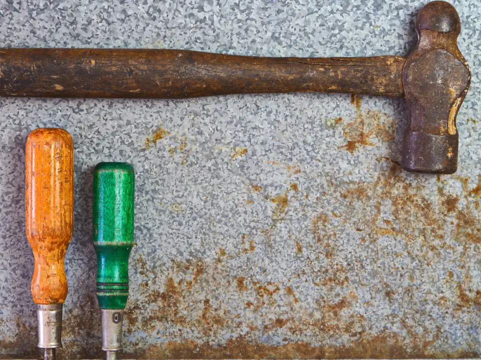 Old hand tools on a stone surface